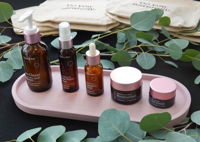 Several brown bottles of skincare products on a pink tray.
