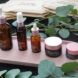 Several brown bottles of skincare products on a pink tray.