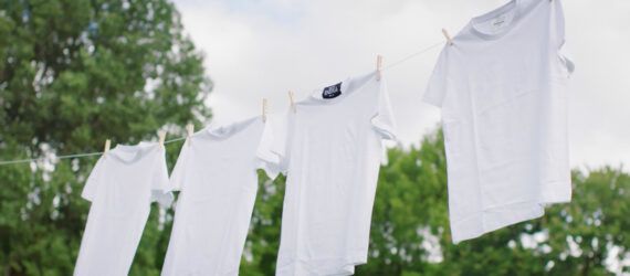 A clothesline of white t-shirts.