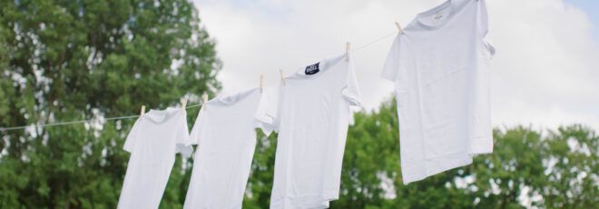 A clothesline of white t-shirts.