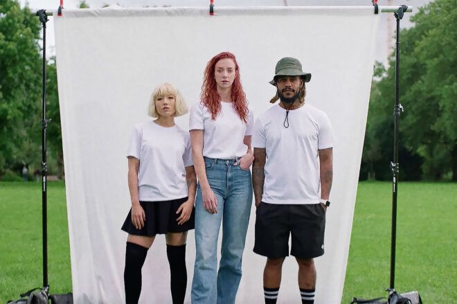 Three people against a white backdrop wearing white t-shirts.