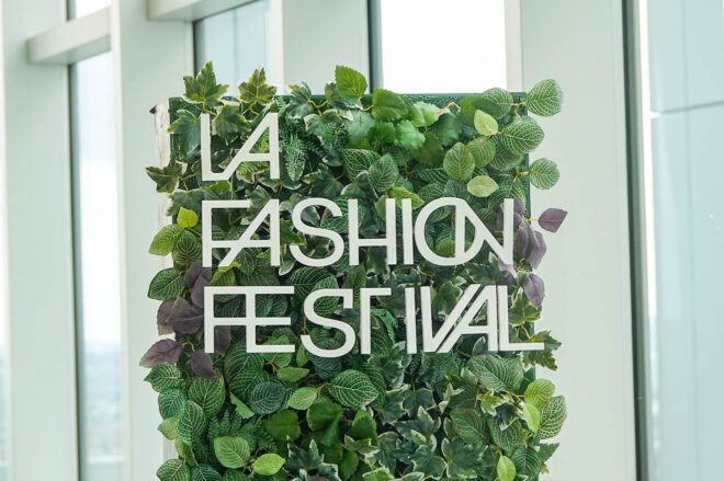 Green sign made out of fake leaves that reads LA Fashion Festival
