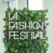 Green sign made out of fake leaves that reads LA Fashion Festival