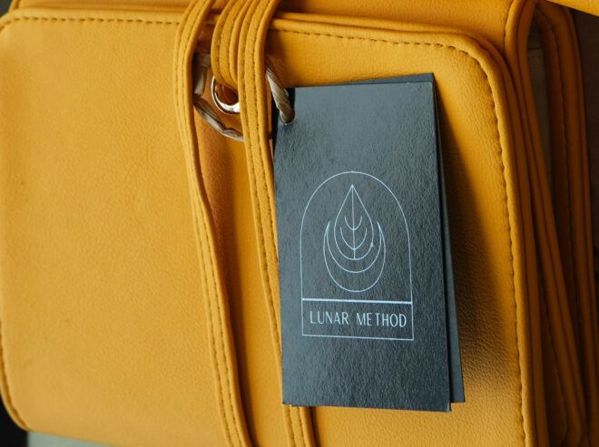 A yellow vegan leather bag with a black tag.