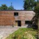 Outside side of wooden building with the drive way