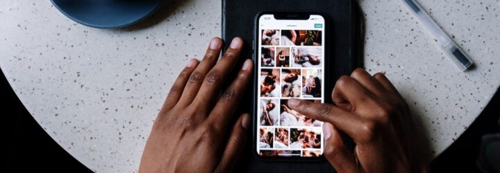 A hand scrolling through a phone