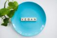 A blue plate with Scrabble tiles spelling the word 