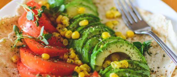 A vegan dish with tomato and avocado.