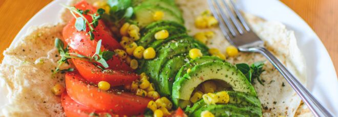 A vegan dish with tomato and avocado.