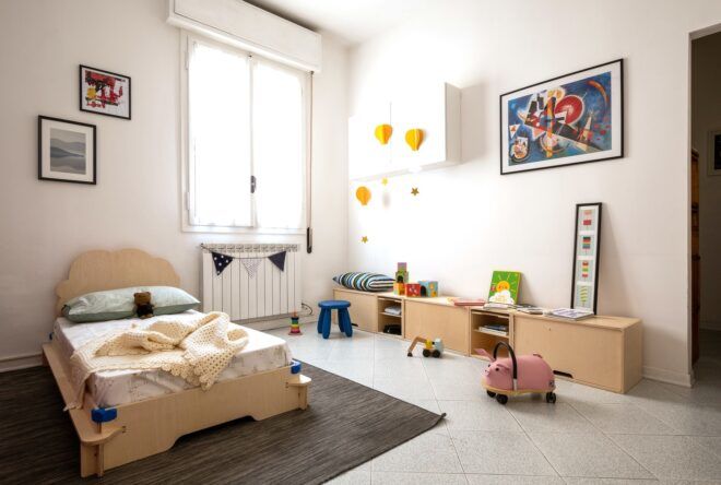 A children's bedroom with an area against the wall for playing with toys