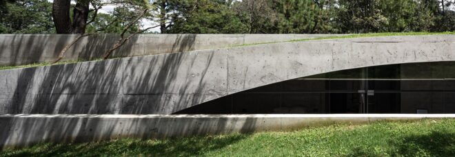 A metal structure that peaks from the grass