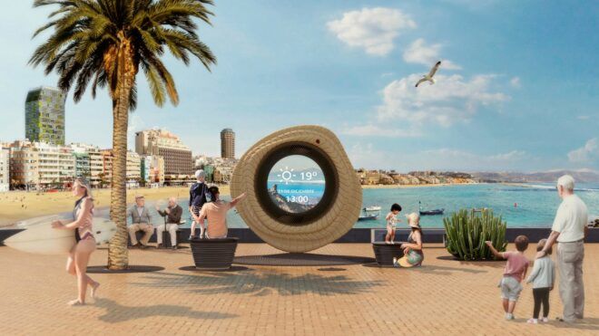 A large circle ring that it has a see through middle sits by the ocean