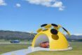 A yellow dome with solar panels protruding from the top.