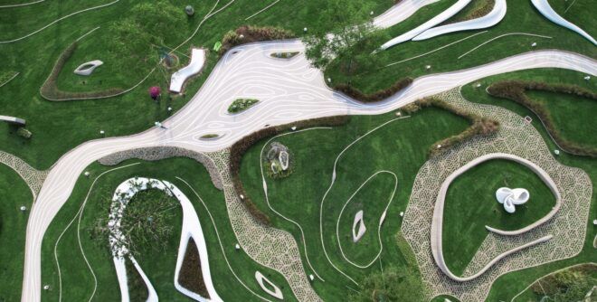 An aerial view of a concrete park surrounded by lush greenery.