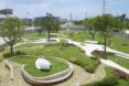 A green park with minimalist concrete paths.