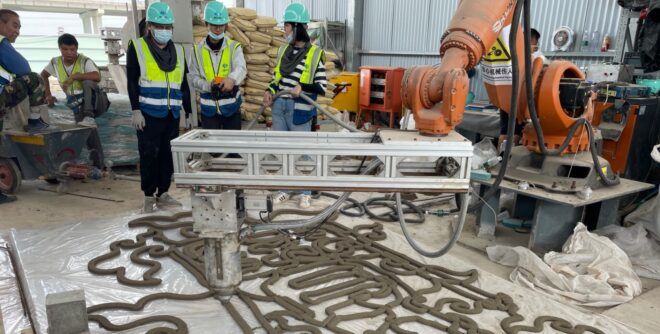 People on a construction site working with robotic equipment.