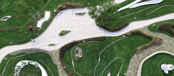 An aerial view of a concrete park surrounded by lush greenery.