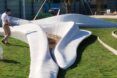 An abstract, 3D-printed sculpture on a green lawn.