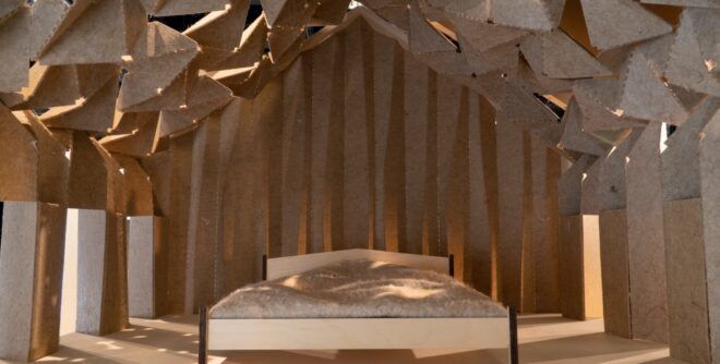 A bed room with a patterned ceiling with lots of fabricated patterns