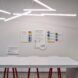 A white wall with papers that talk about LEED certification of the building with a white table in front of it