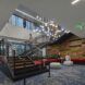 A staircase and underneath the staircase is a lounging area with sofas and foot rests