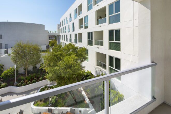 An overview look over a railing of a building with lots of windows