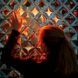 A person touching a display of diamond shaped cut outs