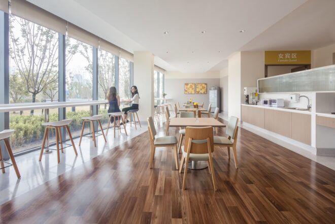 Inside seating area with wood floors and floor-to-ceiling windows