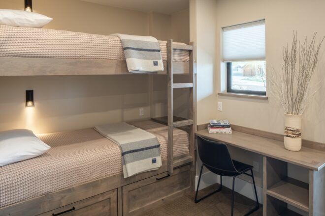 A bunk bed with a desk