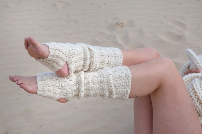 Wool leg warmers against a sandy background