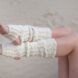 Wool leg warmers against a sandy background