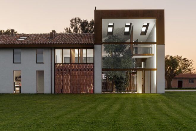 A green lawn in front of a house.