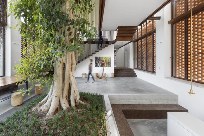 An L-shaped interior hallway with a tree to the left.