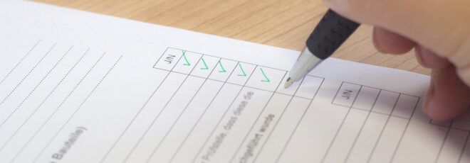 A pen checking off a list.