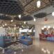A room with a lounging area in the left and a cafeteria to the right