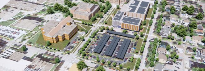 A rendering of an aerial view of a building and parking lots with solar panels on the roof.