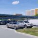 A parking lot with solar panel parking sheds.