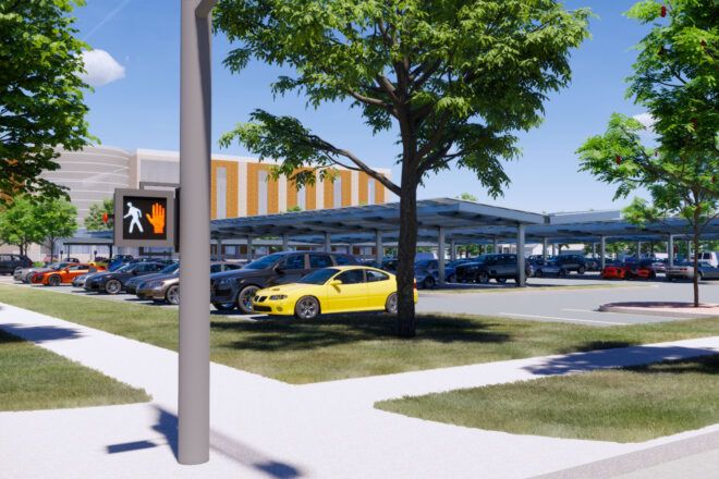 A parking lot with solar panel parking sheds.