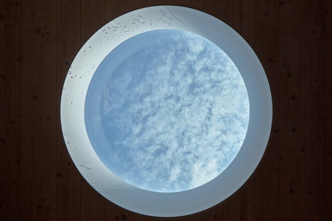 A circle cut out with the clouds covering into it