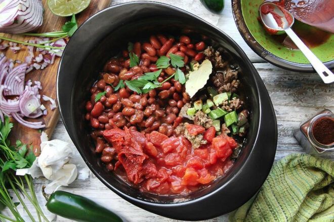 A black ceramic pot full of food.