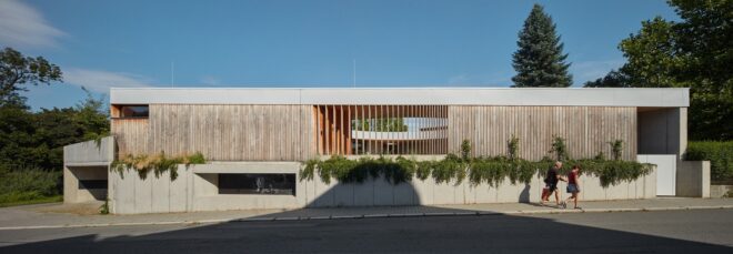 A rectangle building with vertical wood bar designs