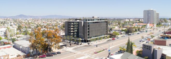 A building sits in a busy city during daytime