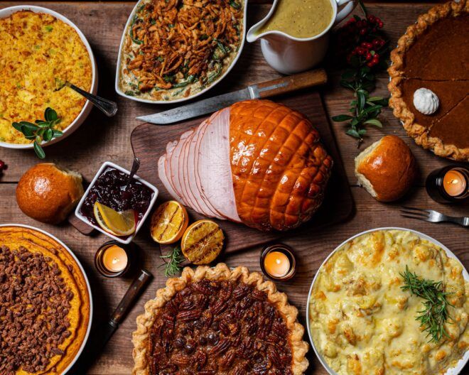 A table spread with turkey, pies, mashed potatoes and gravy