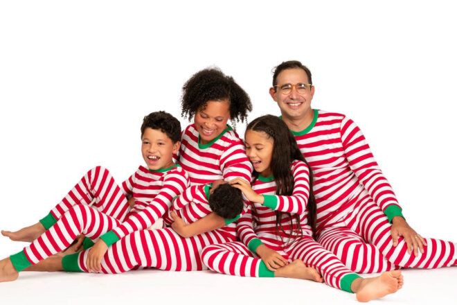 A family in matching Christmas pajamas.