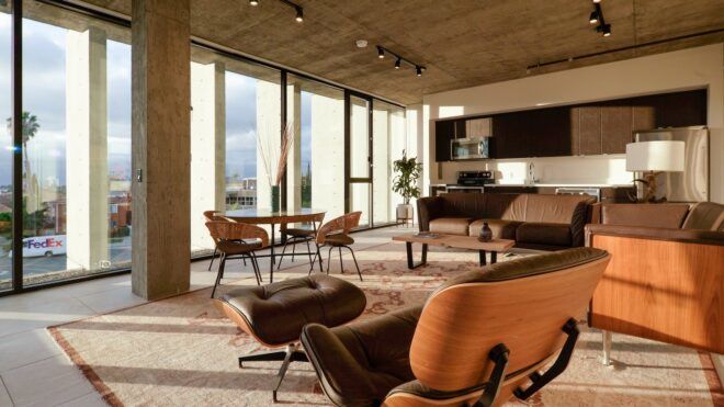 Inside office space with chairs sitting on a rug with floor-to-ceiling windows