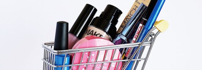Makeup products in a mini shopping cart