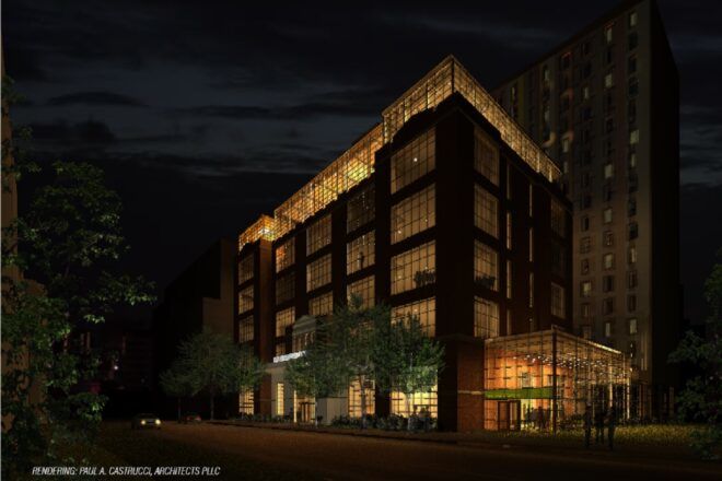 A skyscraper-looking building lit up at nighttime
