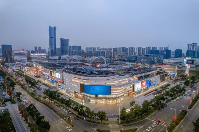 A mall structure at the corner of a busy street