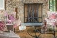A stone living room with pink furniture.