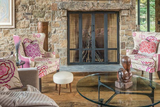 A stone living room with pink furniture.